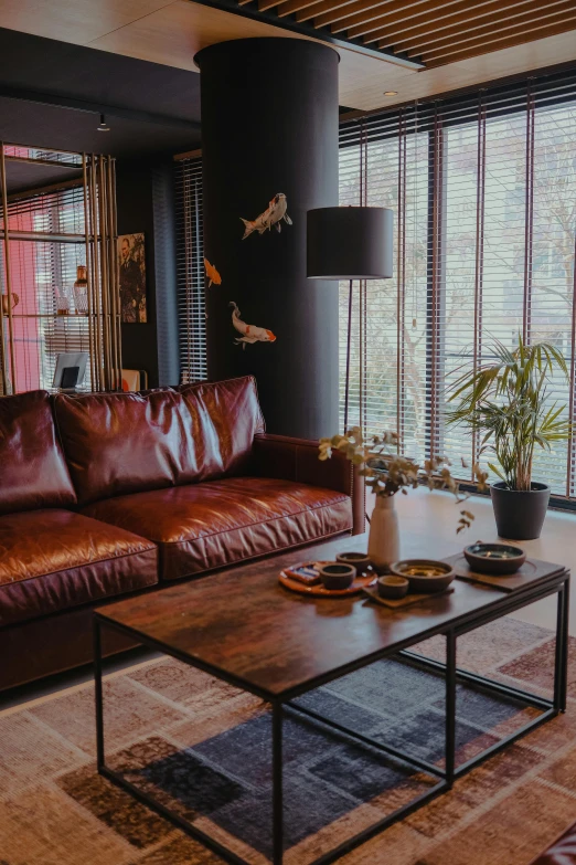 a very elegant and tidy living room with brown leather