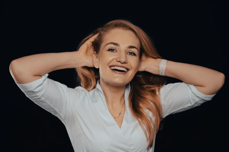 a beautiful woman smiling with her hands behind her head