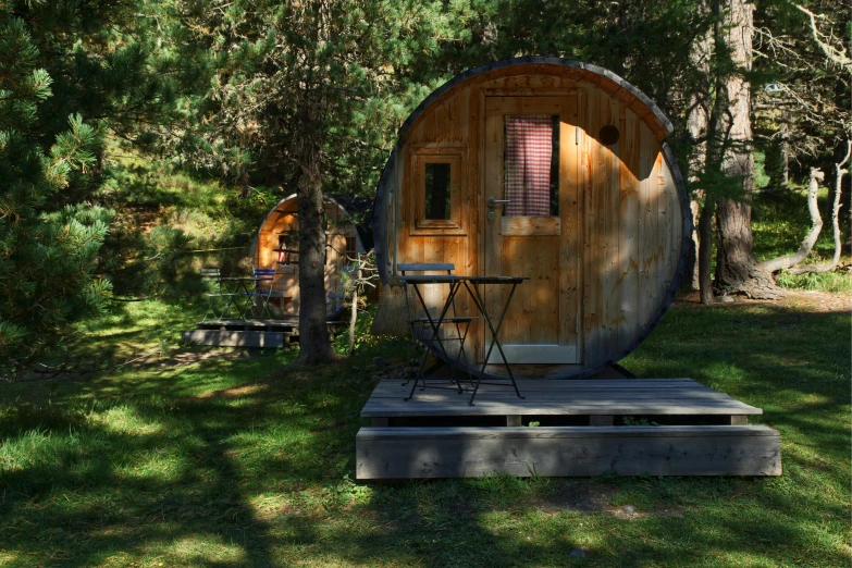 the wooden barrel house is built into the grass