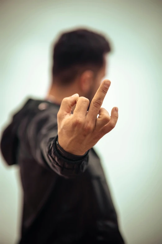 a man making the finger sign with his hand