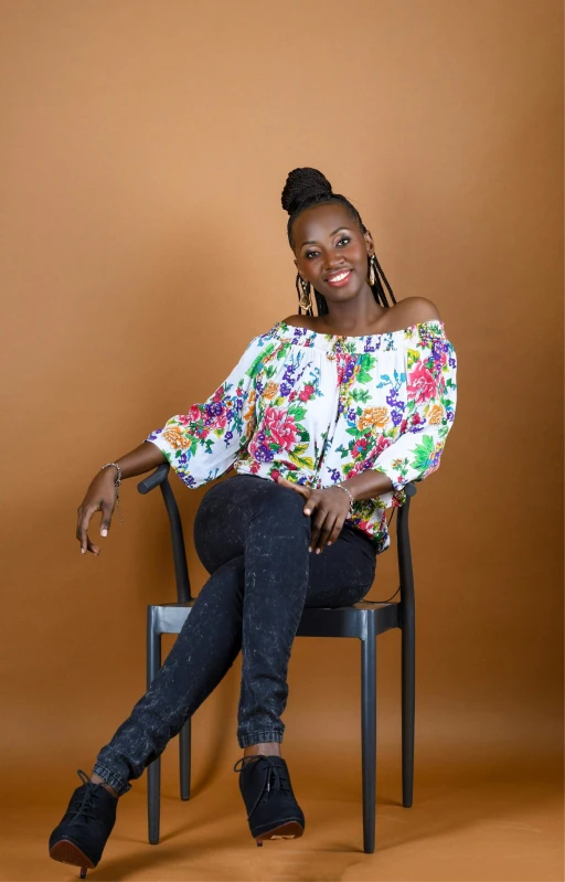 a smiling woman sitting on top of a wooden chair