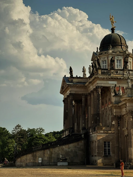 an old building is shown with the sky behind it