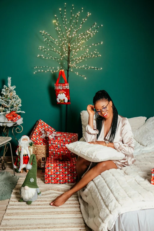 there is a woman talking on the phone while sitting on her bed