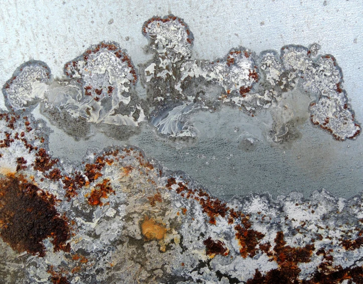 a frosted surface with lots of small patches of rust