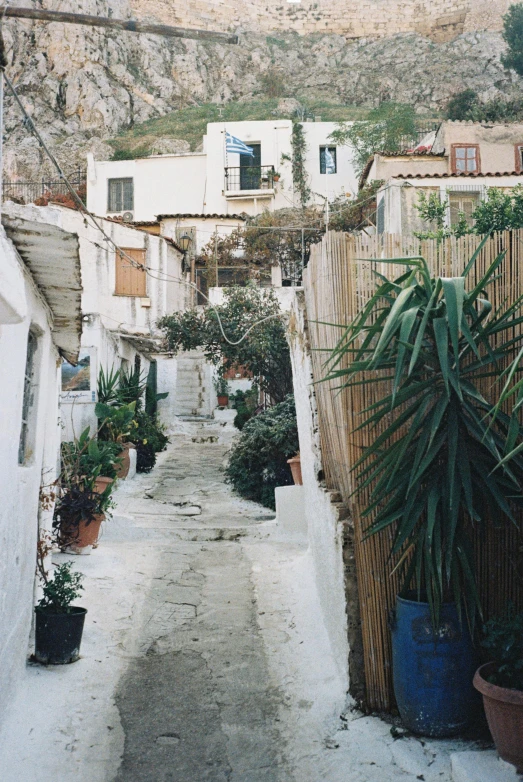 an alley way leads to a hillside in this village