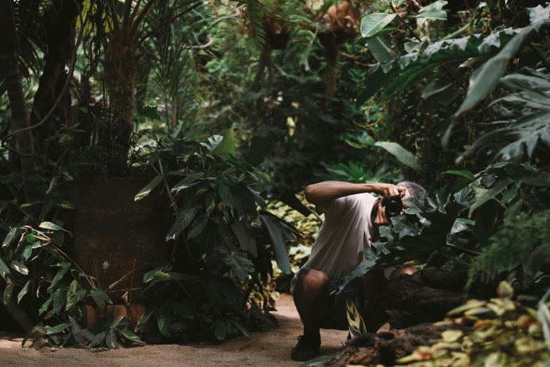 a woman taking a po of herself in a jungle