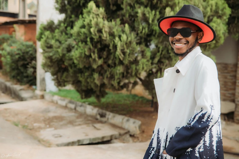 a person in a white jacket and a hat and some trees