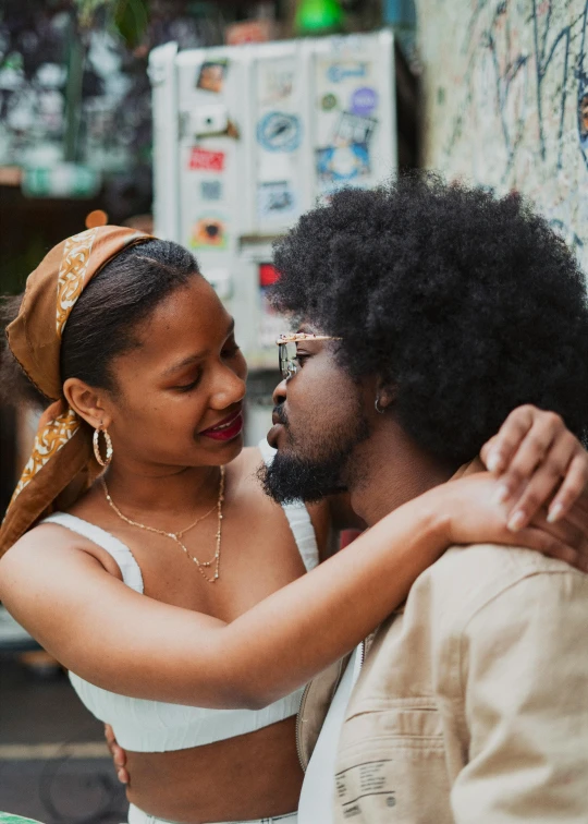 a man is hugging a woman on the street