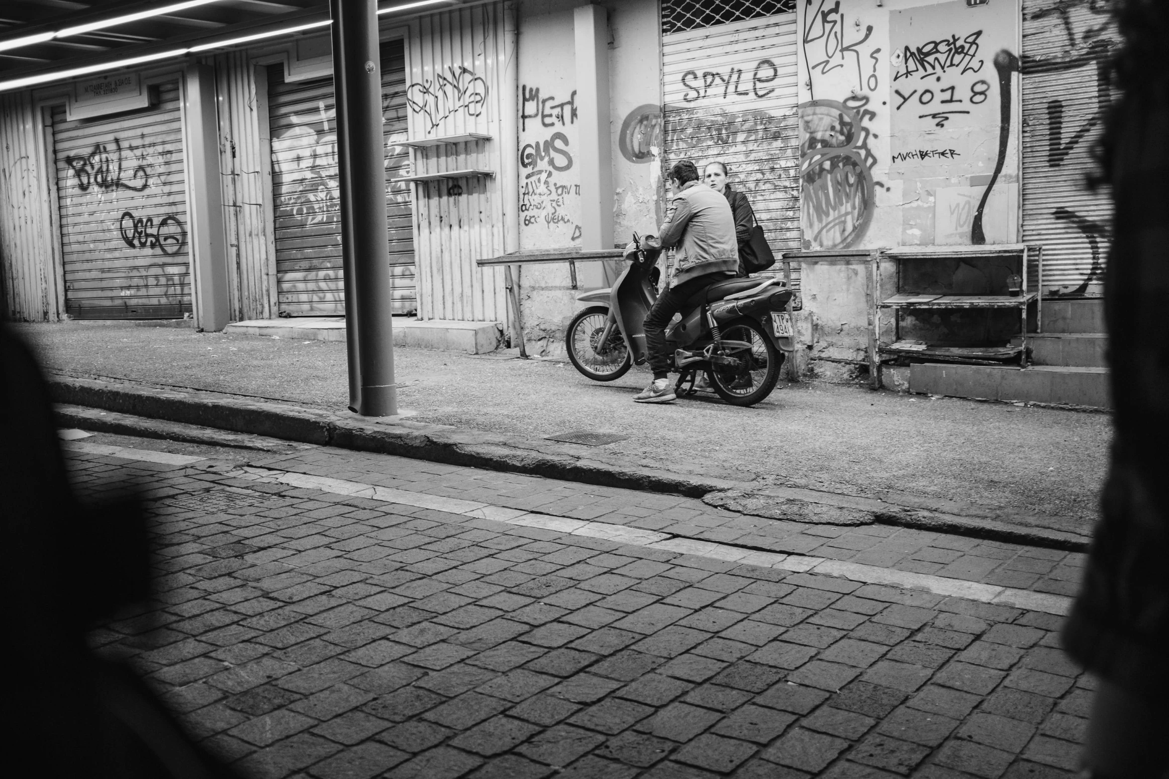 the motorcyclist is riding through a city sidewalk