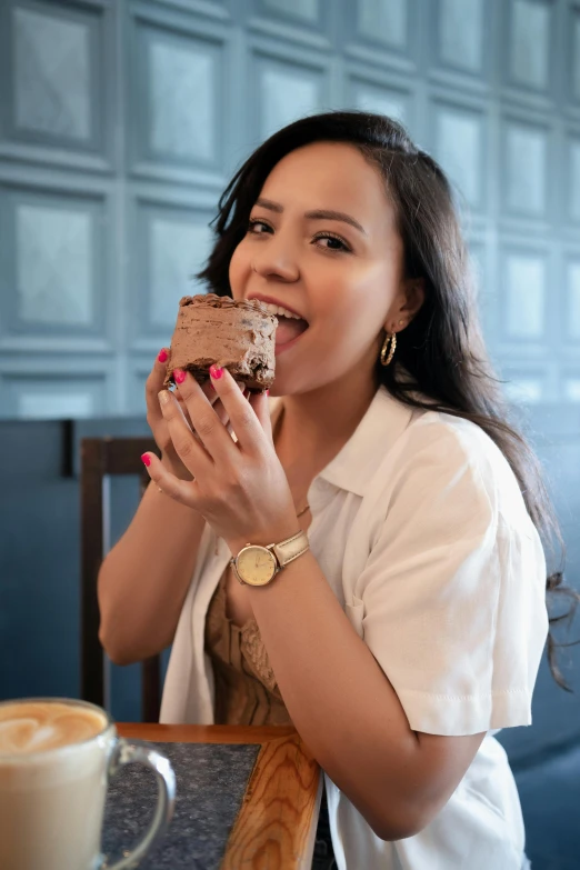 a woman sitting at a table eating food