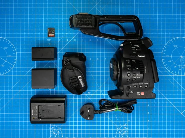 a sony camera with accessories sitting on a blue sheet