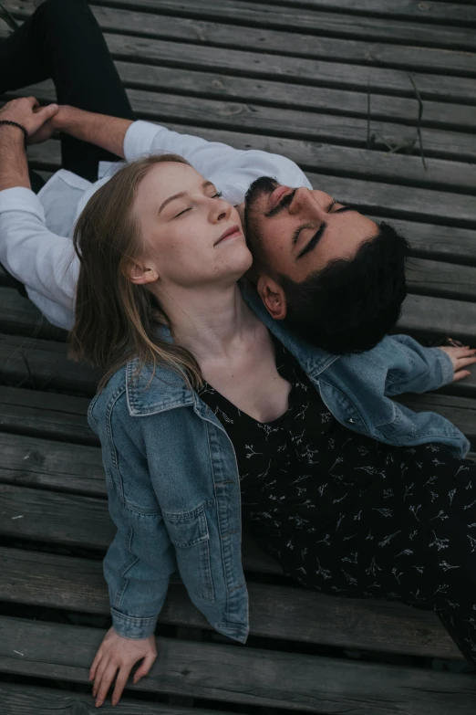 a woman and man laying down in a stadium