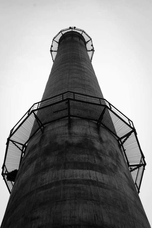 the top of a black and white po of a tower