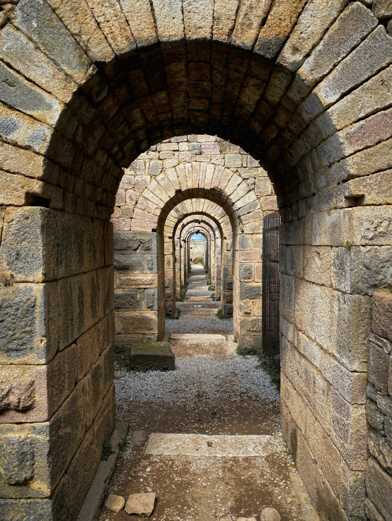 the inside of an arched stone tunnel