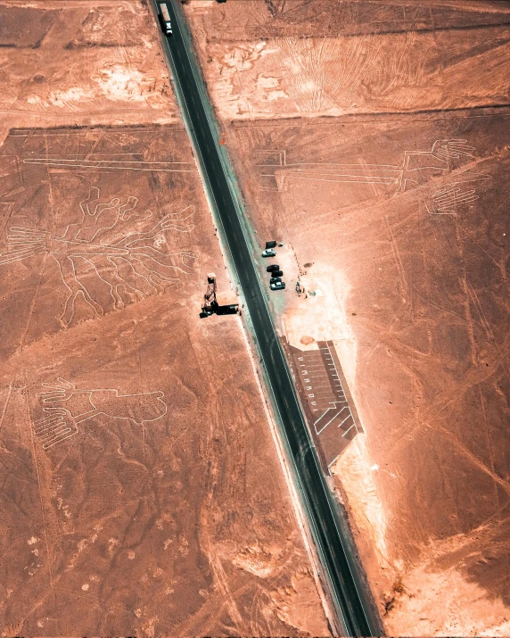 three planes are parked near a highway intersection in the desert