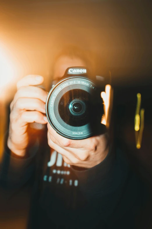 a man holding up a camera to take a picture