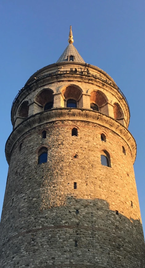 an old stone tower sits on a bright day