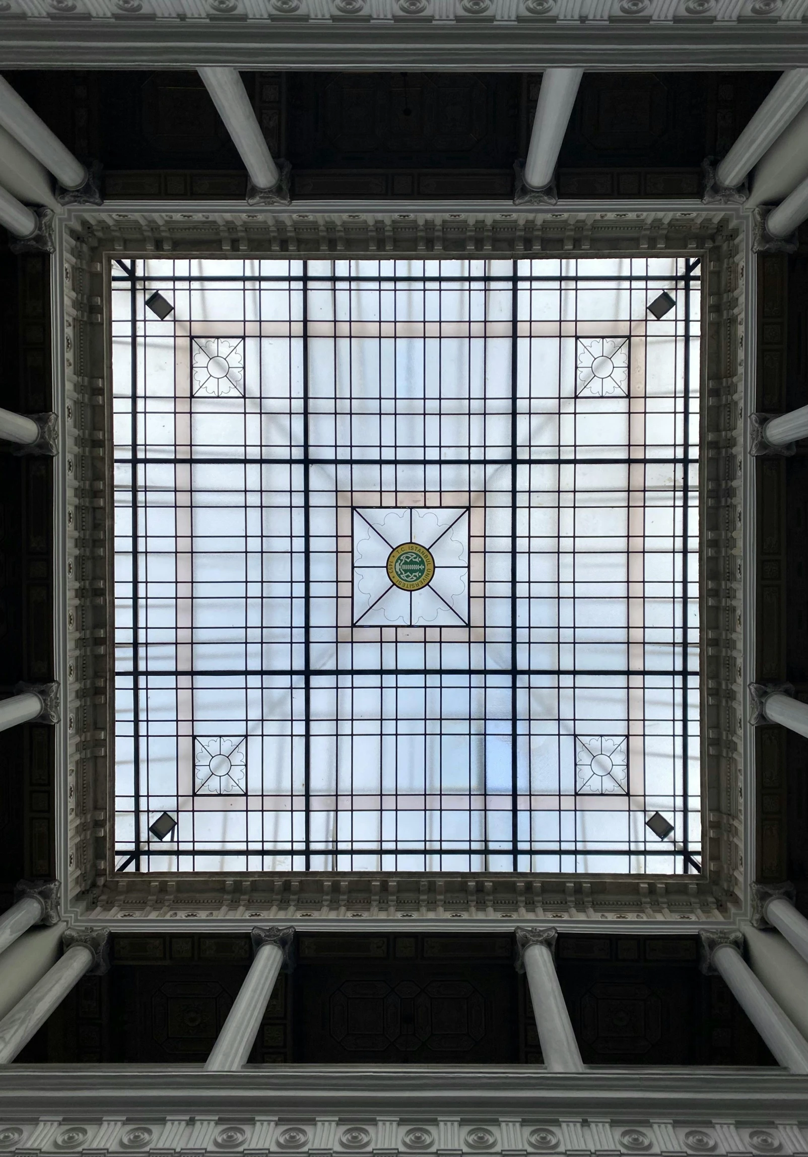 a po looking down at a large white square with a very detailed pattern on it