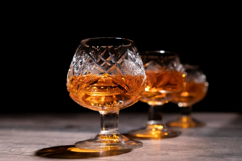 two glass goblets filled with alcohol sit on the table