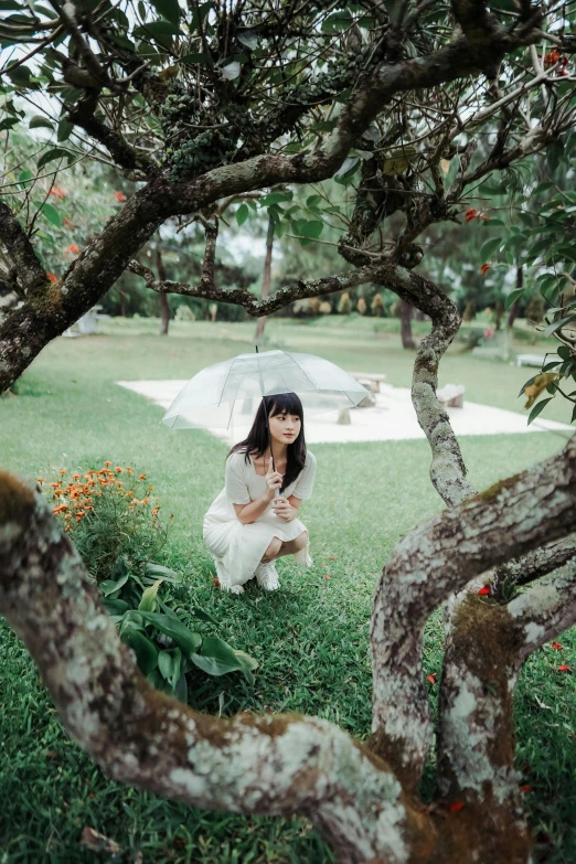 a woman in a white dress and an umbrella