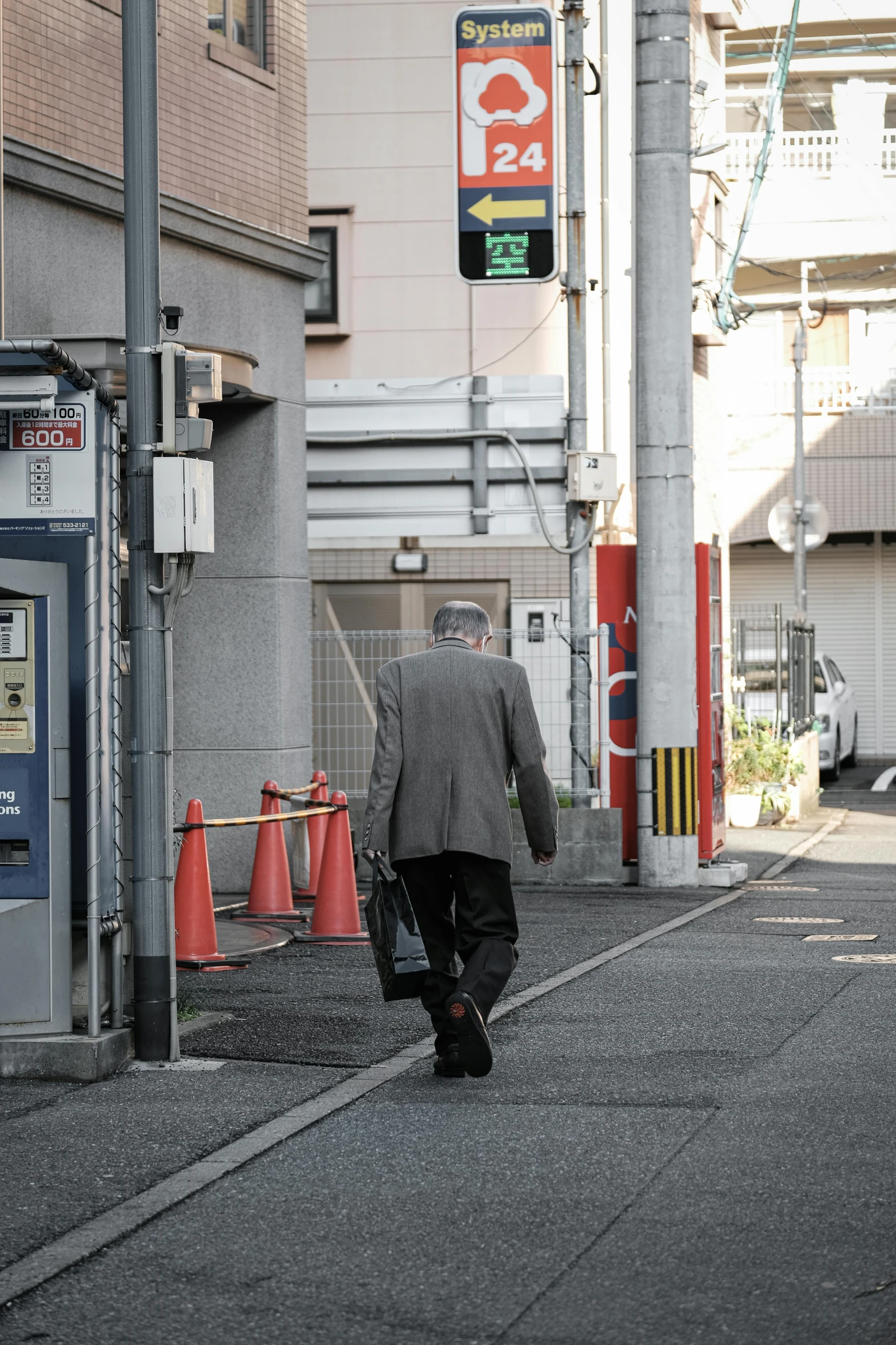 a person walking across a street in the daytime