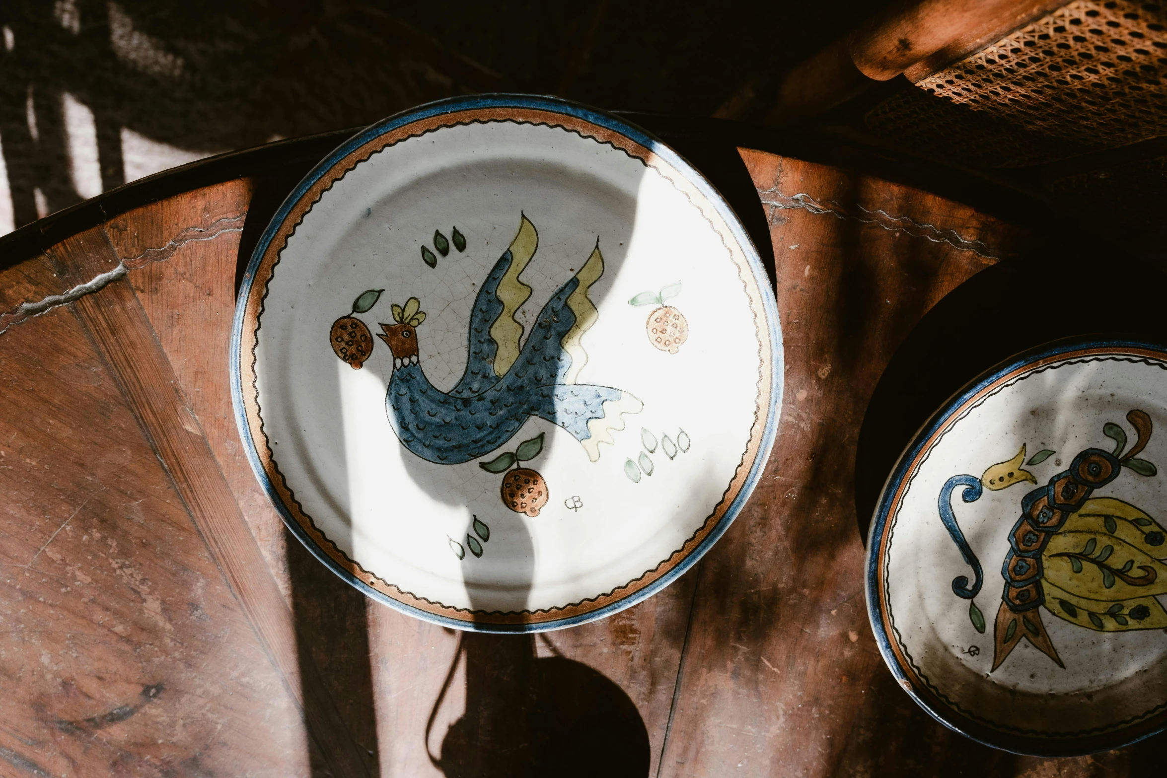 three decorative plates with an image of a bird on them