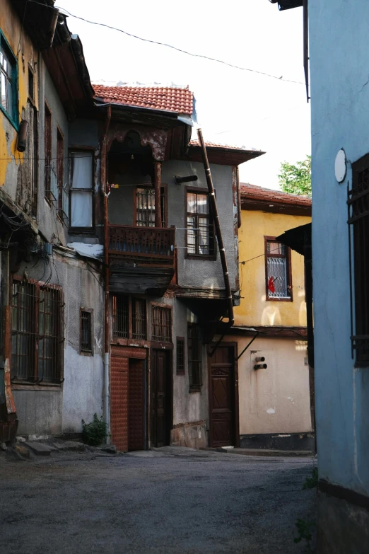 an old street filled with parked cars and lots of doors