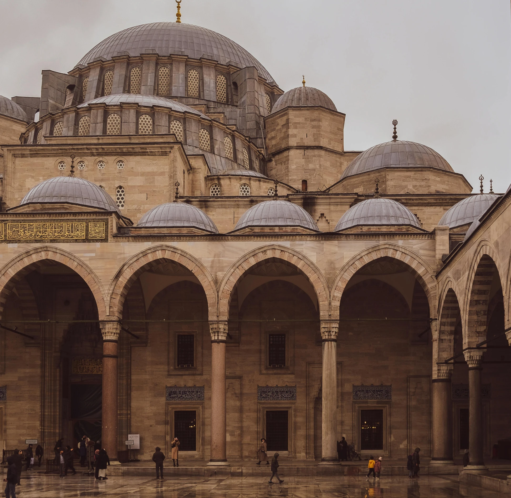 two story building with several arches and domed windows