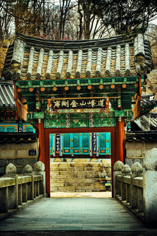 a doorway to the temple with green doors and decorations on it