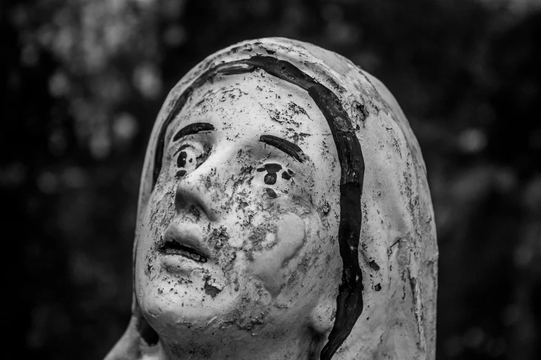 an antique statue with one woman's head covered in liberine