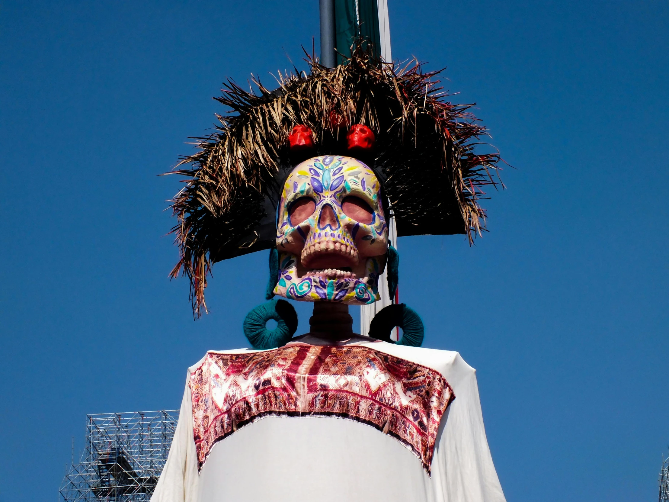 a large colorfully colored face sculpture in the middle of the city