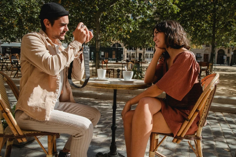 a woman sitting at a table with a man