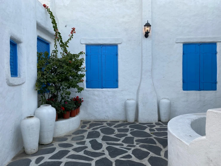 the blue door windows on the side of a white building