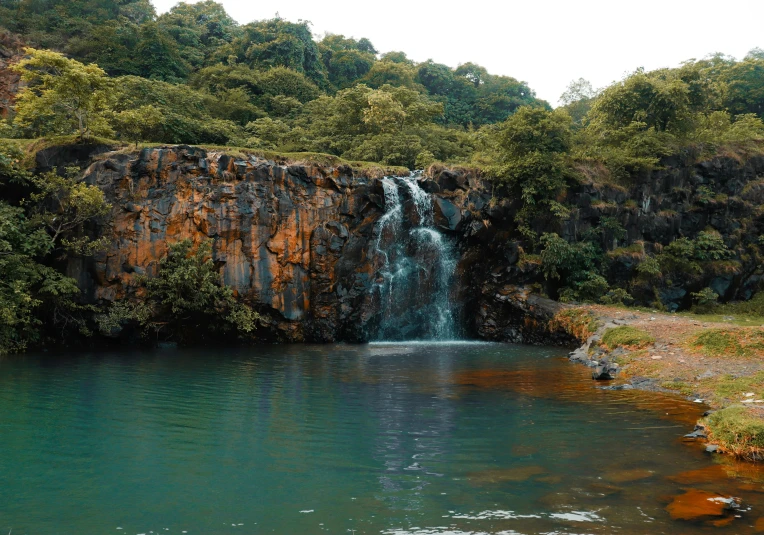 an image of a beautiful waterfall near the lake