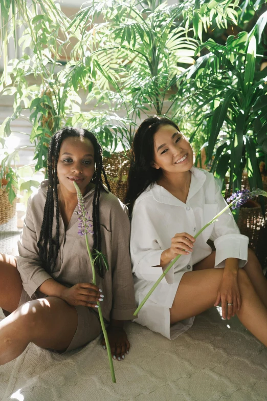 two pretty young women sitting next to each other