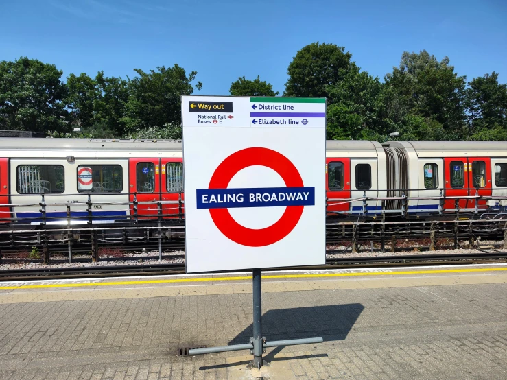 a sign for an empty railway in front of a train