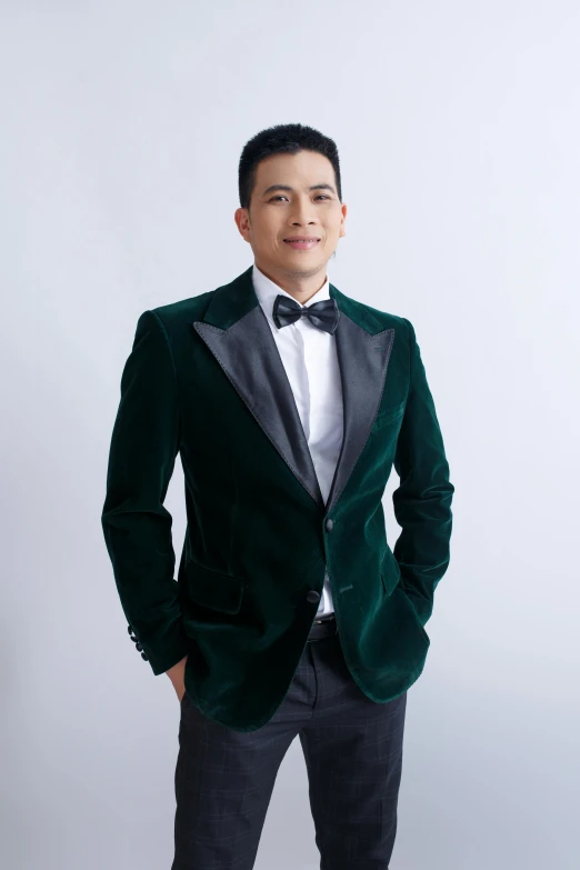 a young man standing in front of a white background