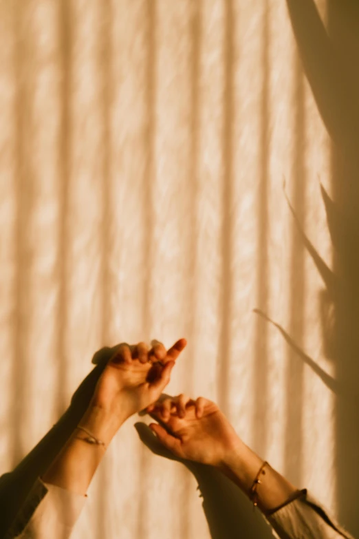 the shadow of two hands reaching out towards each other