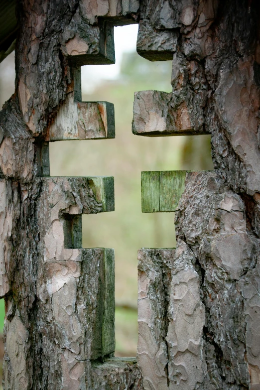 a wooden cross shaped in rock with a wooden cross below