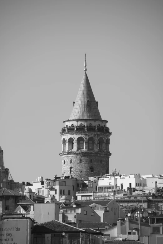 a tower on top of a building near some houses