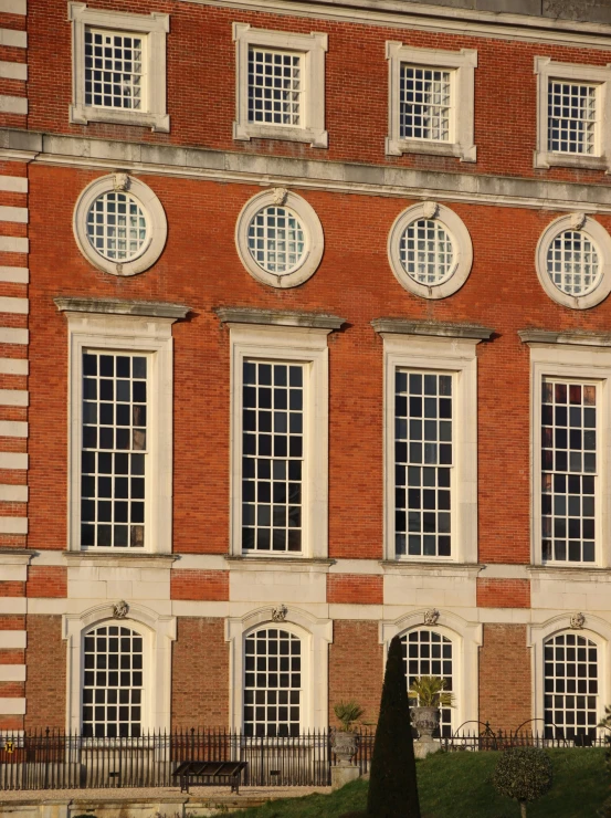 the large brick building is shown with many windows