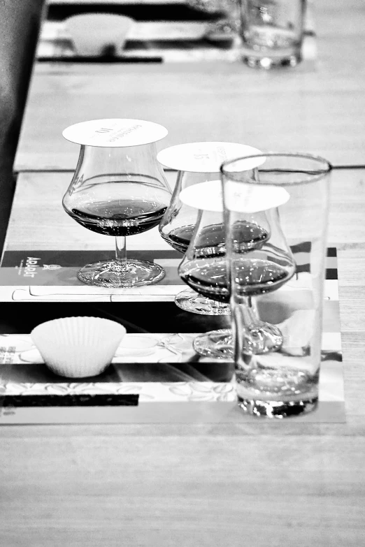 a wooden table topped with glasses and plates of food