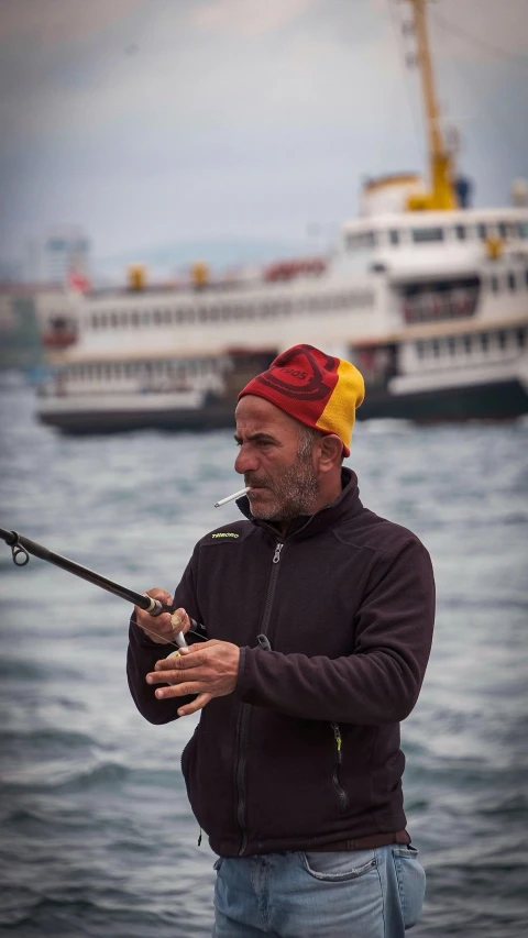 a man that is standing in the water with a rod