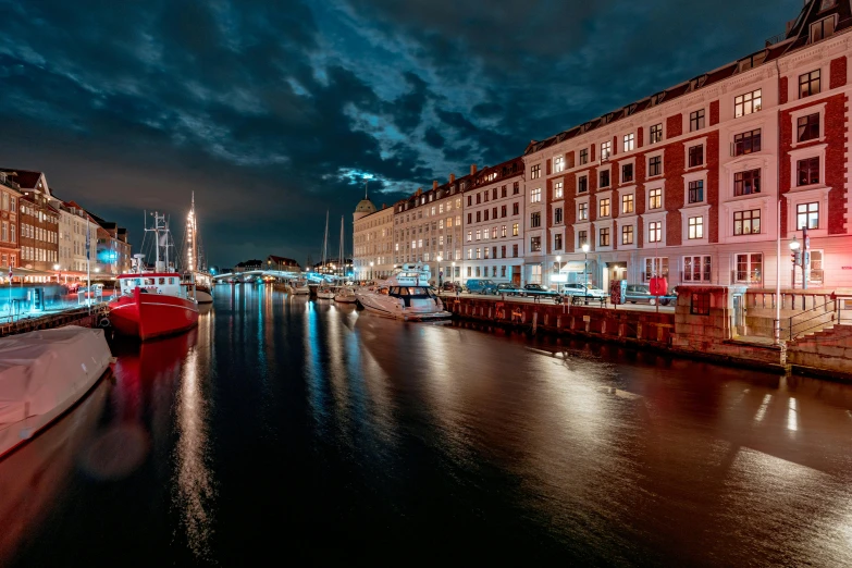 the city lights glow brightly from many different buildings on the waterfront