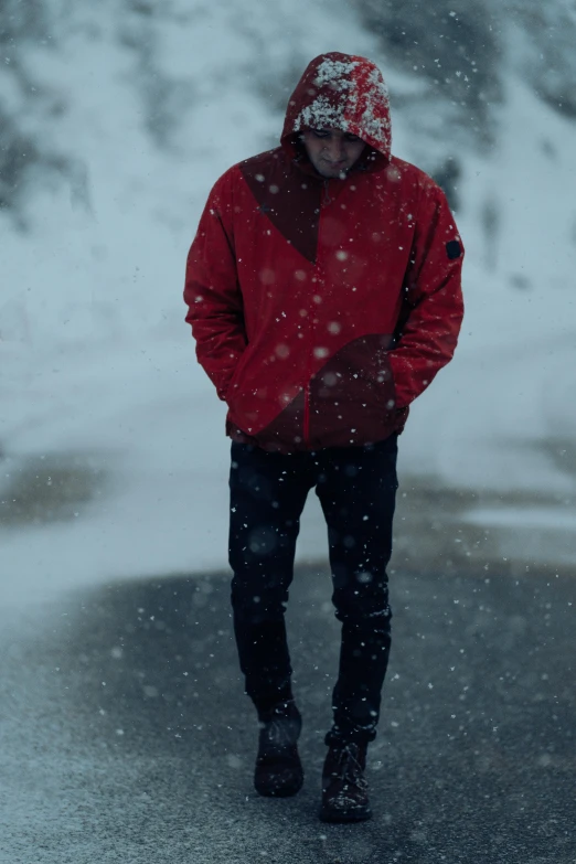 a man in a red jacket is walking outside