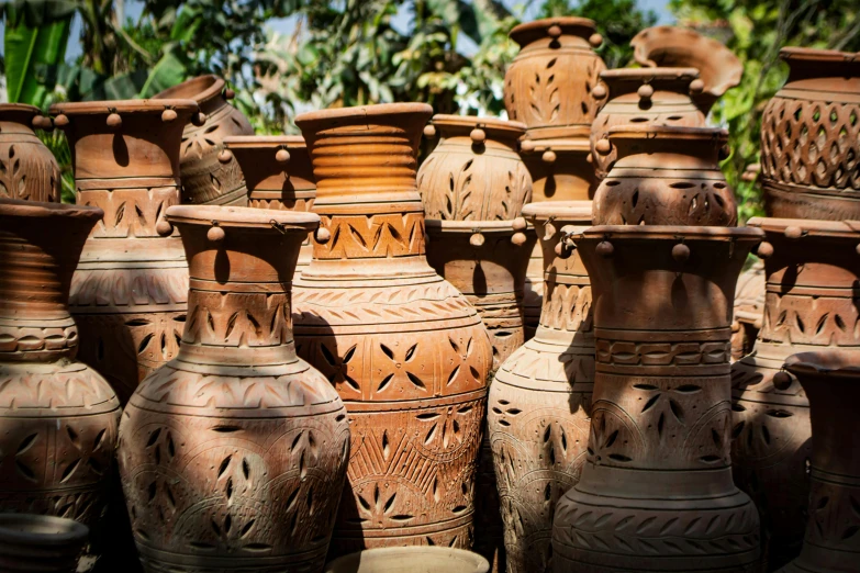 a collection of vases that are brown