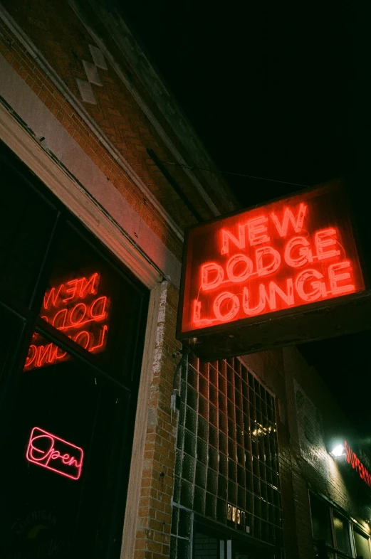 a new dogg lounge sign is in neon lit