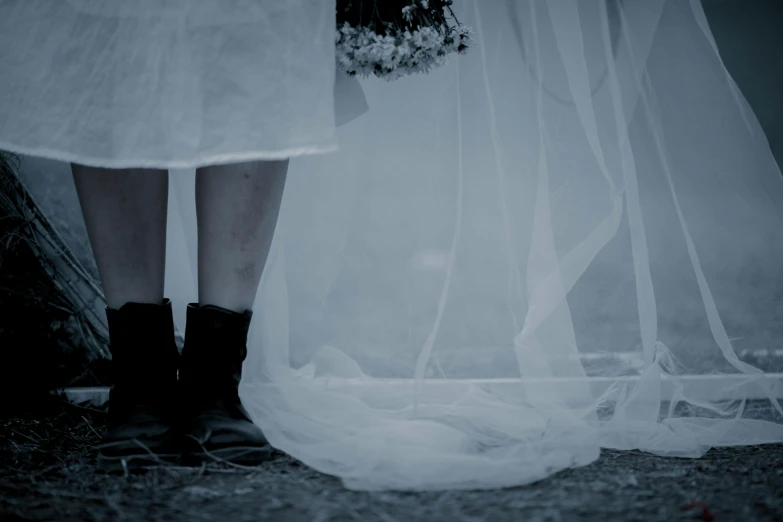 two brides stand next to a couple veiles