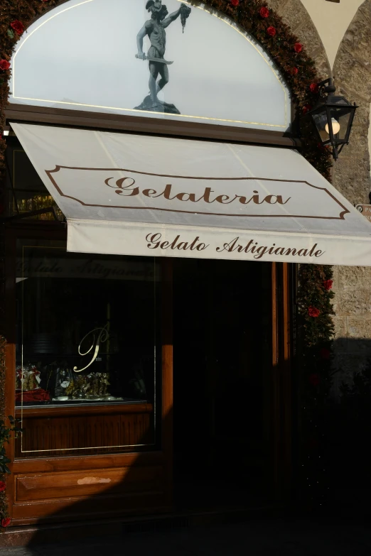 the entrance to a restaurant with a large umbrella