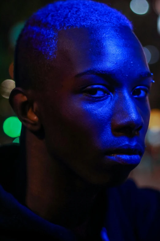 a woman wearing a blue hoodie and posing for the camera